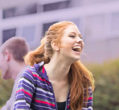 Woman-in-graduation-gown-hugging-person
